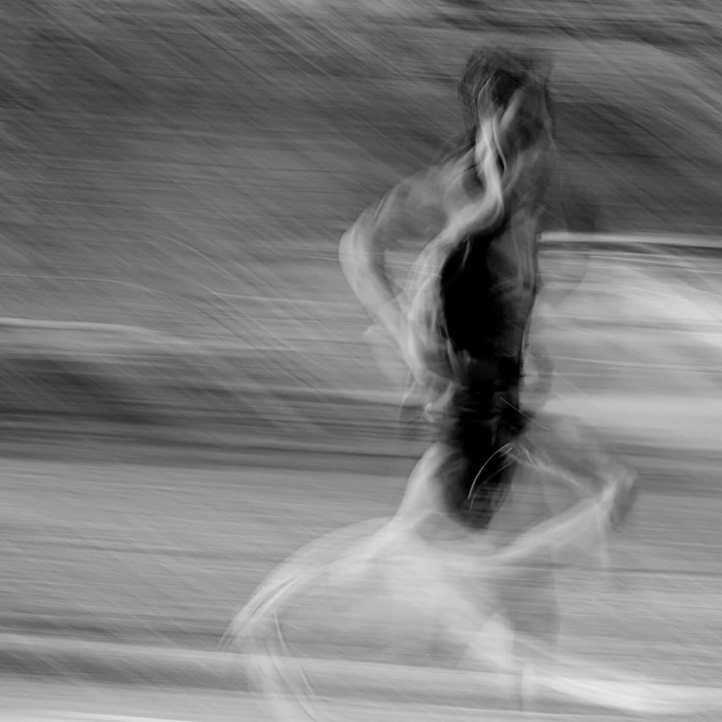Blurred man running in black and white